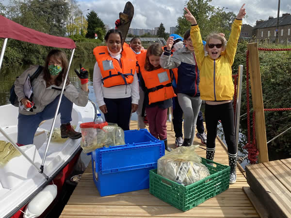 Les enfants collectent les déchets près des rivières et à bateau